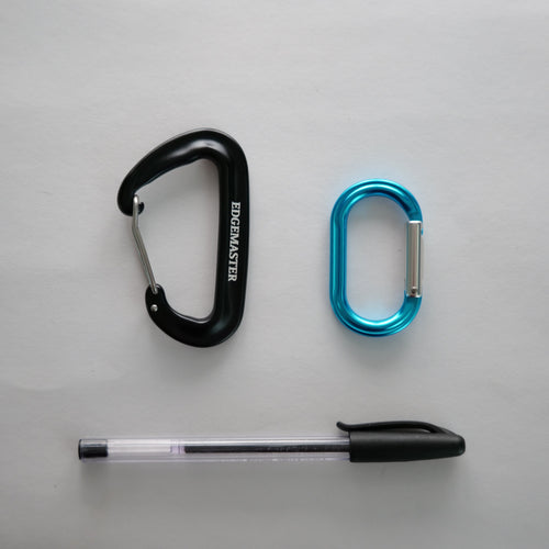 Two carabiners and a pen on a gray background